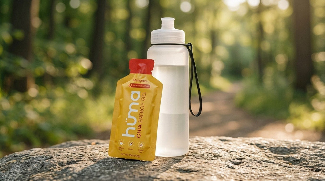 Huma Mangoes energy gel leaning on a runner's water bottle on a trailside rock