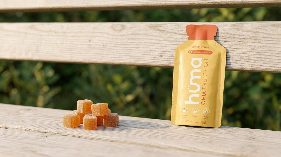 A Huma Mangoes gel on a trailhead bench beside a pile of energy chews