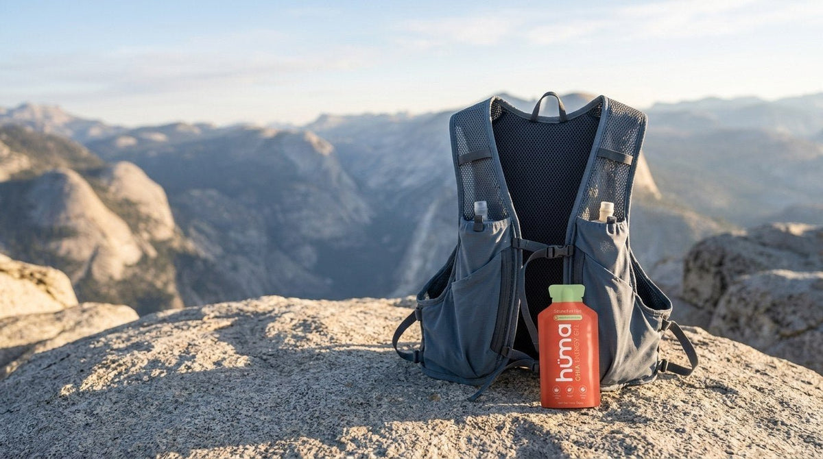 A running hydration vest with a Huma gel on a mountain summit rock