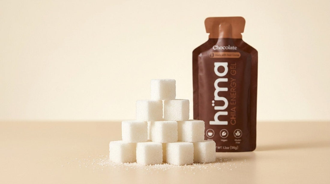 A pile of sugar cubes in front of a Huma Chocolate energy gel