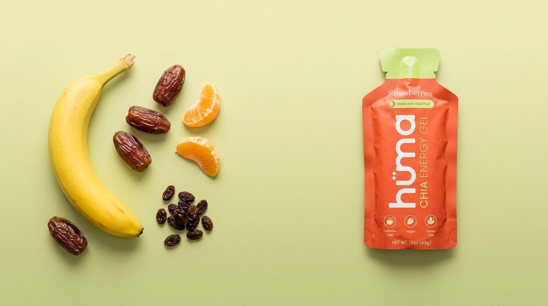 Banana, dates, orange segments, and raisins beside a Huma Strawberries energy gel